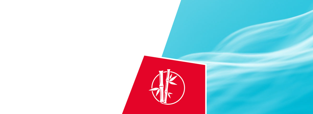 A bright blue sky with soft white wispy clouds in the background. In the lower left corner is a red square icon featuring a white circular logo with bamboo stalks and leaves inside it, representing natural and sustainable materials.