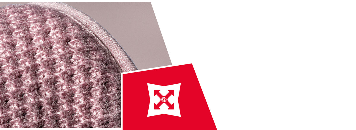 Close-up of pink and gray knitted wool fabric showing detailed texture and stitching. A red icon displays a white shield with arrows, indicating durability or strength properties.