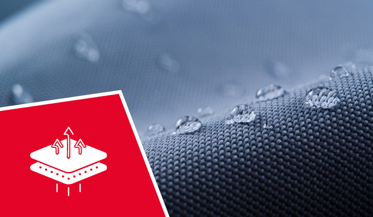 A close-up shot shows a gray, waterproof fabric covered in clear water droplets, which are beaded up on the surface. In the foreground, a red triangular overlay with a white icon is visible in the bottom left corner. The icon depicts two stacked layers with arrows pointing upwards and downwards between them, suggesting breathability and moisture transfer. Below the layers are dotted lines and three vertical bars, possibly indicating different levels or functions.