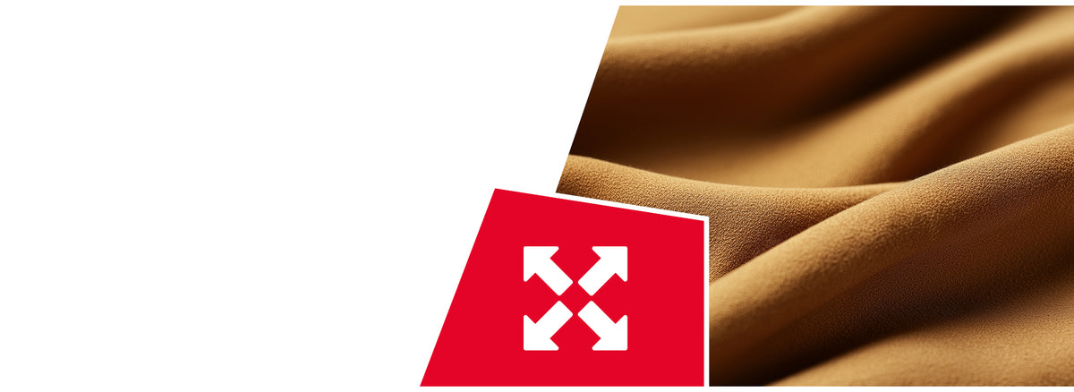 Flowing golden-brown fabric with soft curves and texture. A red icon displays four white arrows pointing outward in all directions, indicating stretch or flexibility properties.