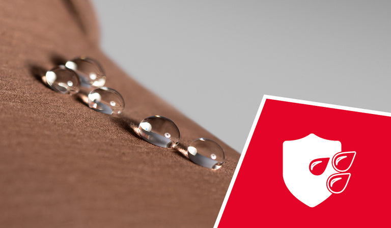 Water droplets beading on brown fabric surface, demonstrating water resistance. A red icon shows a white shield with water droplets, indicating waterproof protection.