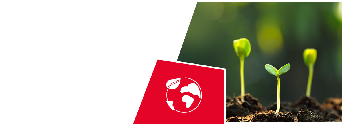Small green seedlings sprouting from dark soil with blurred plants in the background. A red icon shows a white globe with a leaf, indicating environmental sustainability or eco-friendly properties.