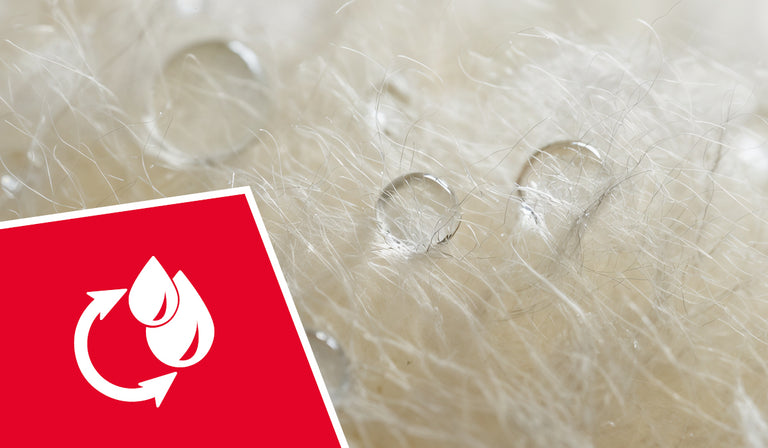 Close-up of fine, curly white wool fibers with natural texture and shine. A red icon shows white water droplets with a circular arrow, indicating moisture-wicking or recyclable properties.